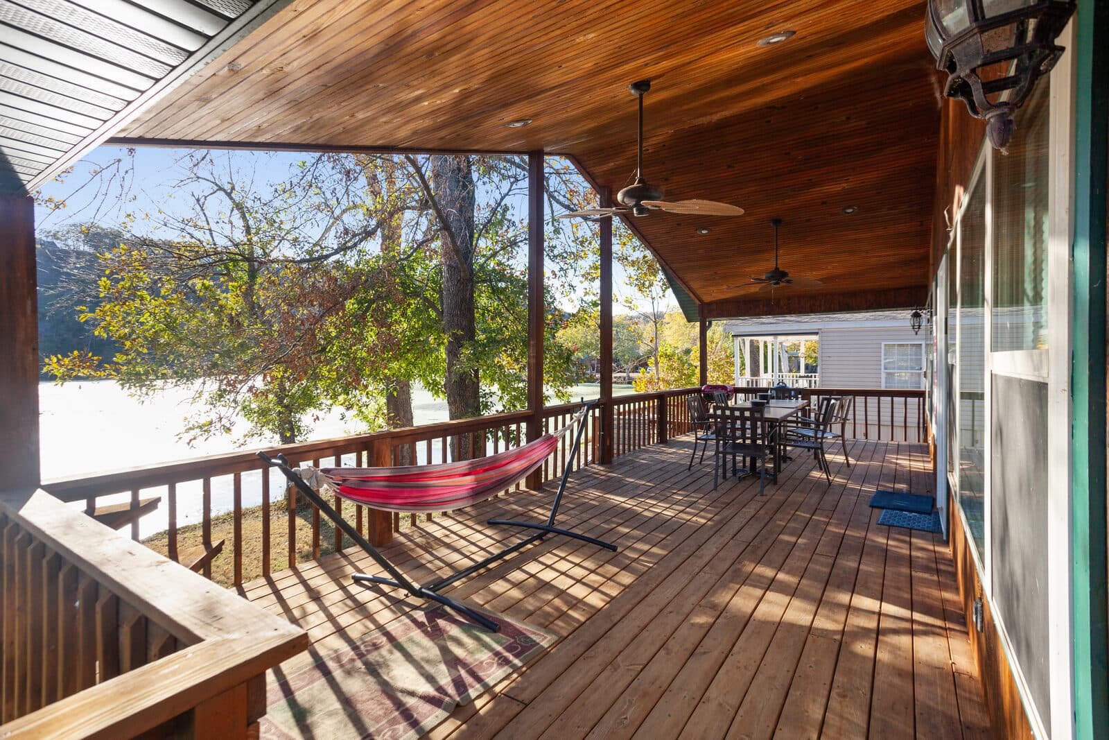 Covered deck with a hammock overlooking the water