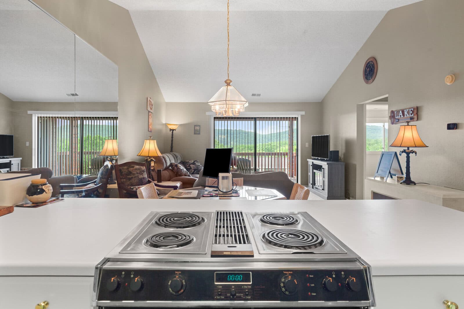 White island kitchen with a wall of windows and a long view