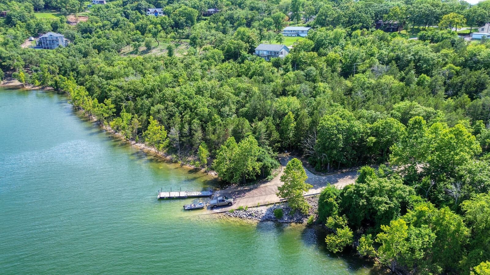 Aerial view of a quiet lake cove with private docks