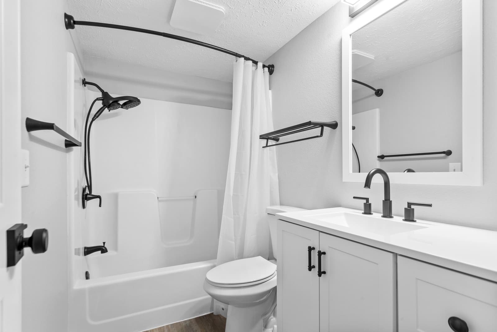 Staged short-term rental bedroom with folded towels on the bed